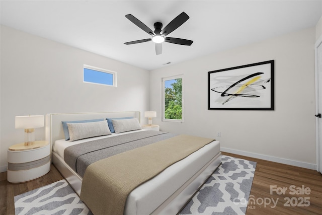 1076 W Henderson St, Marion, NC 28752 - bedroom with baseboards, wood finished floors, and ceiling fan