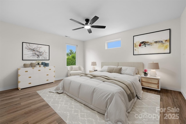 1076 W Henderson St, Marion, NC 28752 - bedroom with wood finished floors, a ceiling fan, and baseboards