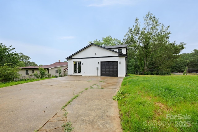 1076 W Henderson St, Marion, NC 28752 - modern inspired farmhouse with concrete driveway and an attached garage