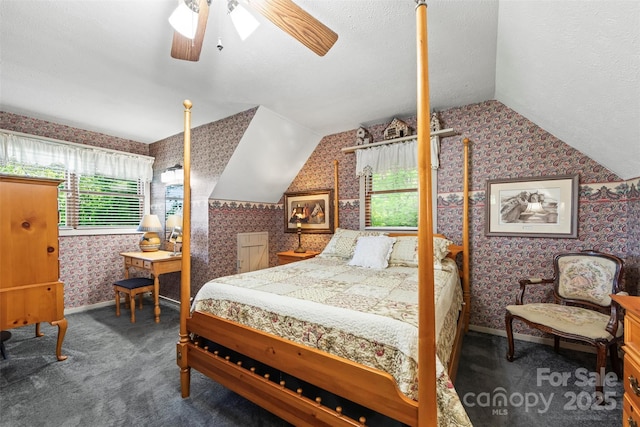260 Smoky View Dr, Bryson City, NC 28713 - carpeted bedroom with wallpapered walls, vaulted ceiling, baseboards, and a ceiling fan