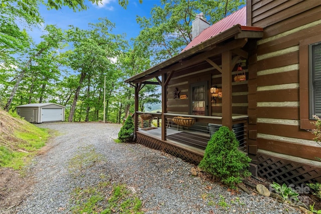 260 Smoky View Dr, Bryson City, NC 28713 - view of side of property with metal roof, an outdoor structure, gravel driveway, a chimney, and a detached garage