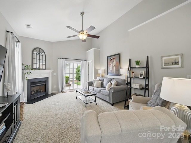 1061 Woodglen Ln, Matthews, NC 28104 - living room featuring carpet flooring, a ceiling fan, a fireplace with flush hearth, baseboards, and high vaulted ceiling