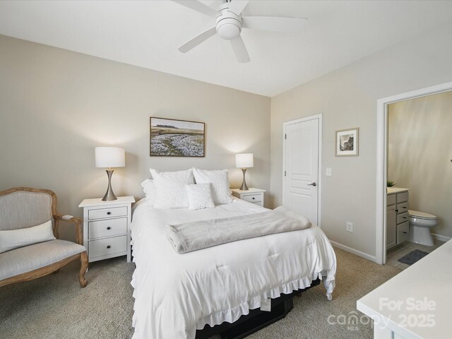 1061 Woodglen Ln, Matthews, NC 28104 - bedroom with light colored carpet, ensuite bath, ceiling fan, and baseboards