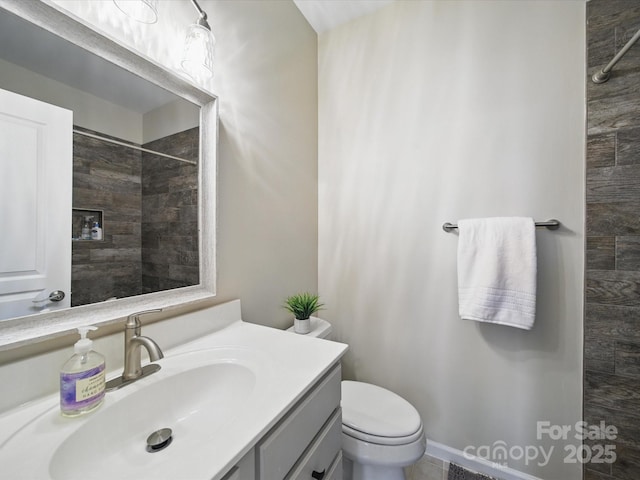 1061 Woodglen Ln, Matthews, NC 28104 - bathroom featuring vanity, a tile shower, and toilet