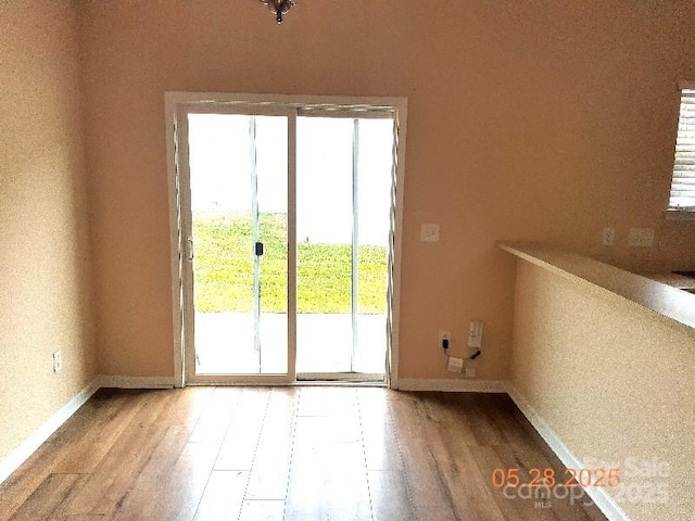13441 Calloway Glen Dr, Charlotte, NC 28273 - doorway with wood finished floors, plenty of natural light, and baseboards