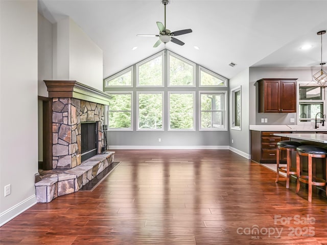110 Village Pointe Ln, Asheville, NC 28803 - unfurnished living room featuring ceiling fan, vaulted ceiling, a fireplace, and dark wood-type flooring