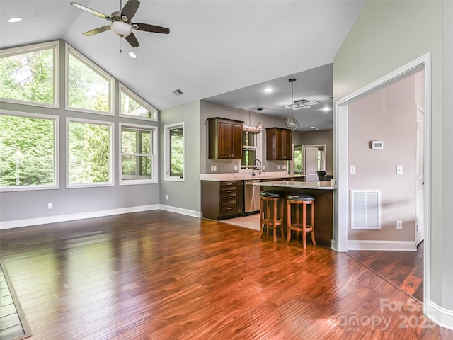 110 Village Pointe Ln, Asheville, NC 28803 - kitchen featuring light countertops, dark brown cabinetry, a ceiling fan, stainless steel dishwasher, and a breakfast bar area