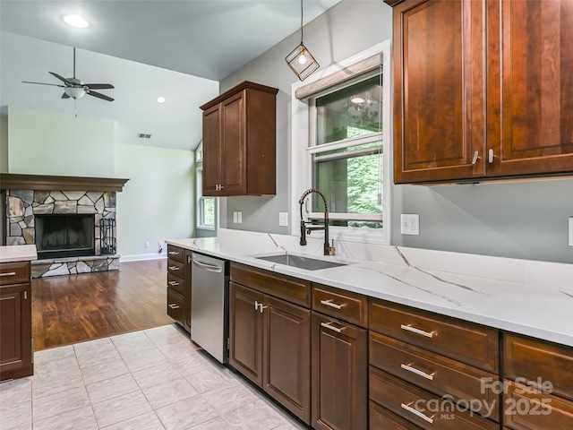 110 Village Pointe Ln, Asheville, NC 28803 - kitchen featuring stainless steel dishwasher, a ceiling fan, open floor plan, a stone fireplace, and light stone counters