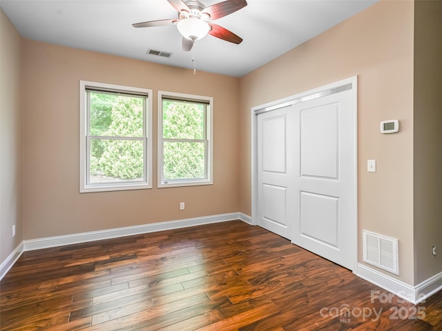 110 Village Pointe Ln, Asheville, NC 28803 - unfurnished bedroom featuring dark wood-type flooring, a closet, and a ceiling fan