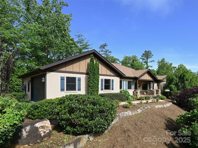 110 Village Pointe Ln, Asheville, NC 28803 - ranch-style house featuring a porch, board and batten siding, and an attached garage