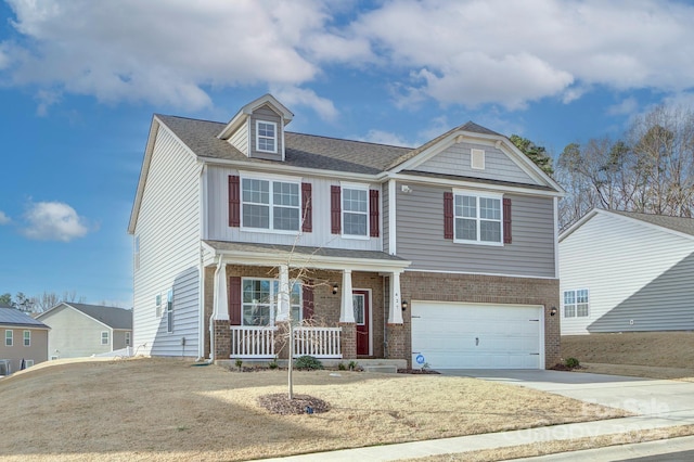 427 Carolina Hemlock Dr, Locust, NC 28097 - view of front of house with a porch, brick siding, a garage, and concrete driveway