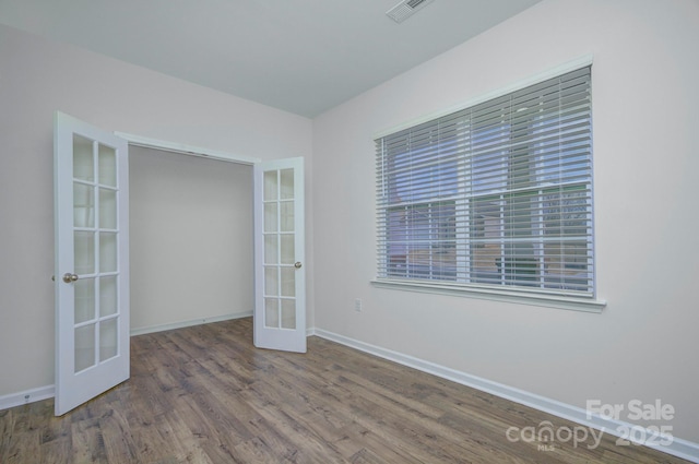 427 Carolina Hemlock Dr, Locust, NC 28097 - unfurnished room with french doors, wood finished floors, and baseboards