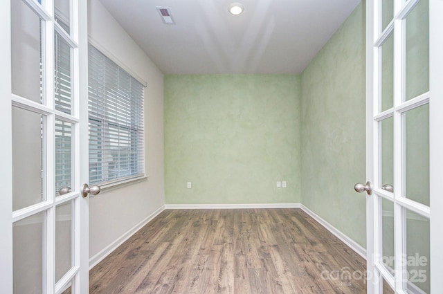 427 Carolina Hemlock Dr, Locust, NC 28097 - unfurnished bedroom with french doors, wood finished floors, and baseboards
