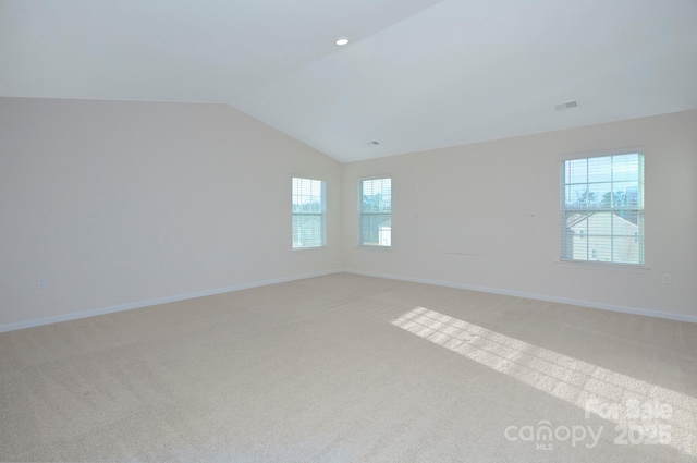 427 Carolina Hemlock Dr, Locust, NC 28097 - spare room featuring light colored carpet, lofted ceiling, and baseboards