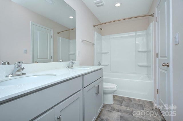 427 Carolina Hemlock Dr, Locust, NC 28097 - bathroom with double vanity, shower / bathtub combination, toilet, and stone finish flooring