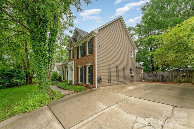 8624 Canter Post Dr, Charlotte, NC 28216 - view of side of home with brick siding and a patio