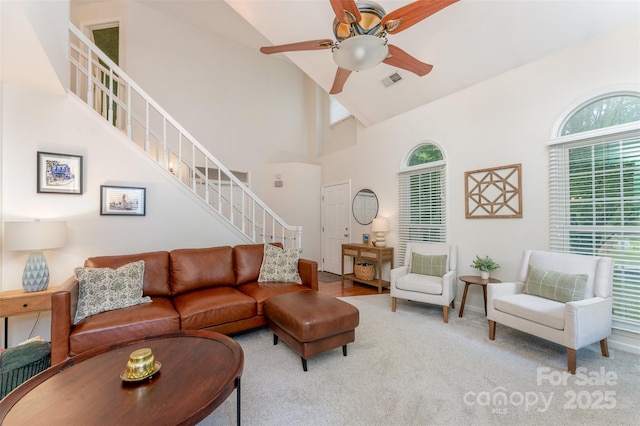 8624 Canter Post Dr, Charlotte, NC 28216 - carpeted living area featuring a high ceiling, ceiling fan, and stairway