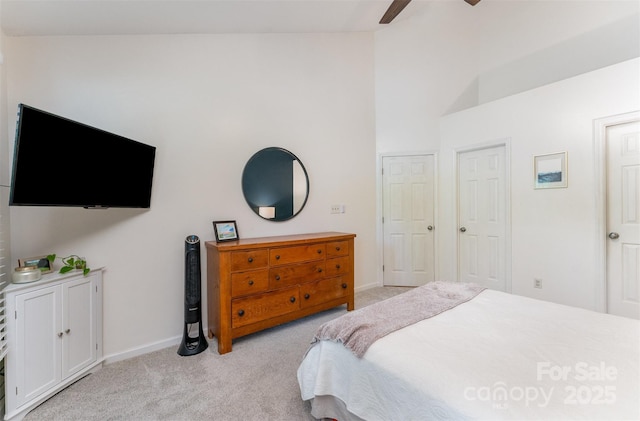 8624 Canter Post Dr, Charlotte, NC 28216 - bedroom featuring light carpet, baseboards, a ceiling fan, and high vaulted ceiling