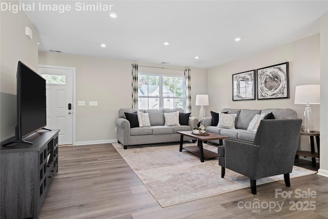 10108 Florentine Way, Charlotte, NC 28214 - living room featuring wood finished floors, baseboards, and recessed lighting
