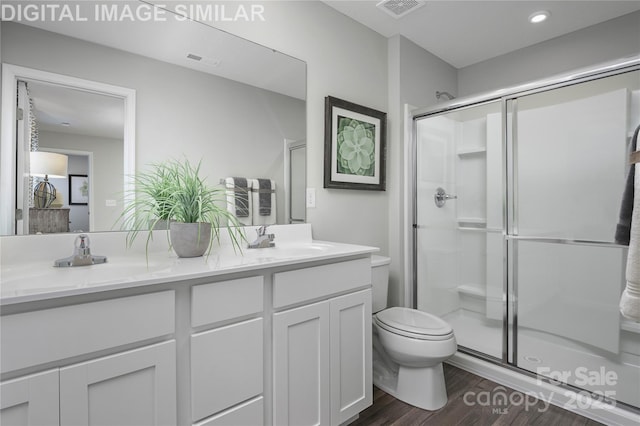 10108 Florentine Way, Charlotte, NC 28214 - full bath featuring toilet, wood finished floors, a stall shower, double vanity, and recessed lighting