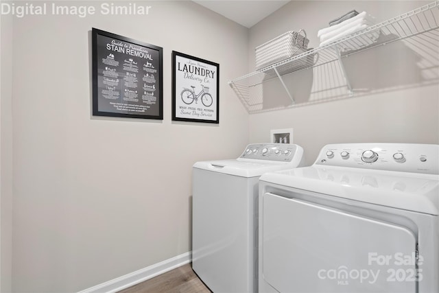 10108 Florentine Way, Charlotte, NC 28214 - laundry area featuring washer and clothes dryer, wood finished floors, and baseboards