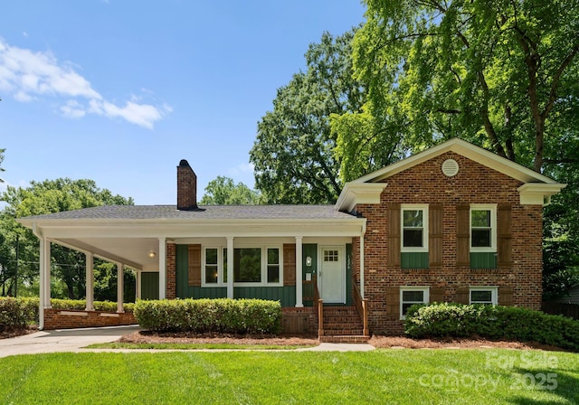 1226 Tarrington Ave, Charlotte, NC 28205 - split level home with a front lawn, a chimney, driveway, and brick siding