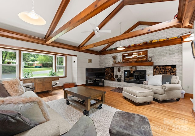 1226 Tarrington Ave, Charlotte, NC 28205 - living room featuring ceiling fan, a large fireplace, light wood finished floors, beamed ceiling, and high vaulted ceiling