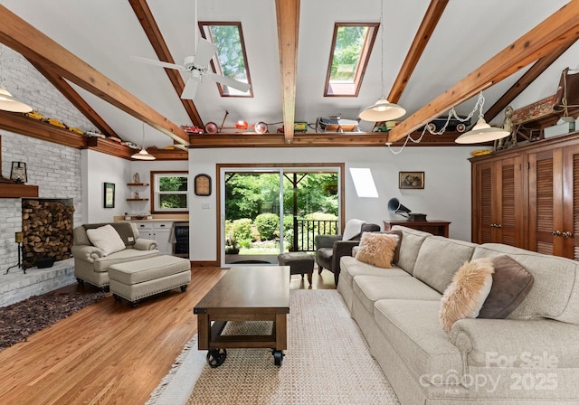 1226 Tarrington Ave, Charlotte, NC 28205 - living area featuring a skylight, beam ceiling, high vaulted ceiling, wood finished floors, and a brick fireplace