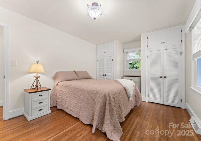 1226 Tarrington Ave, Charlotte, NC 28205 - bedroom featuring light wood-style flooring, baseboards, and two closets