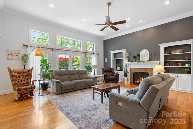 134 Brightmore Cir, Rutherfordton, NC 28139 - living area with a high end fireplace, ceiling fan, light wood finished floors, recessed lighting, and crown molding