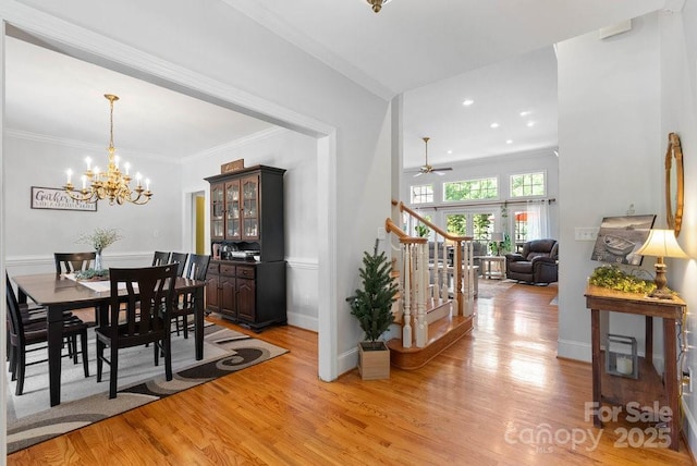 134 Brightmore Cir, Rutherfordton, NC 28139 - dining room featuring stairway, light wood-style floors, a chandelier, ornamental molding, and a ceiling fan