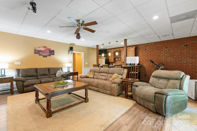 134 Brightmore Cir, Rutherfordton, NC 28139 - living area with a drop ceiling, a ceiling fan, light wood-style floors, bar, and brick wall