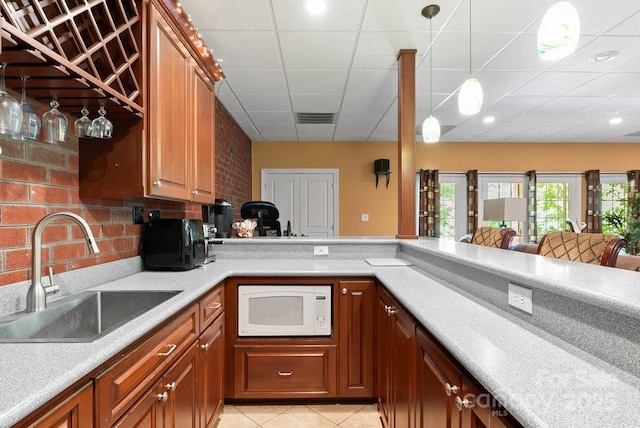 134 Brightmore Cir, Rutherfordton, NC 28139 - kitchen with white microwave, a sink, light tile patterned floors, light countertops, and a paneled ceiling