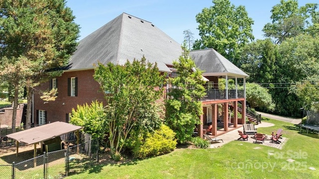 134 Brightmore Cir, Rutherfordton, NC 28139 - rear view of property featuring an outdoor fire pit, stairway, a trampoline, a patio area, and a wooden deck