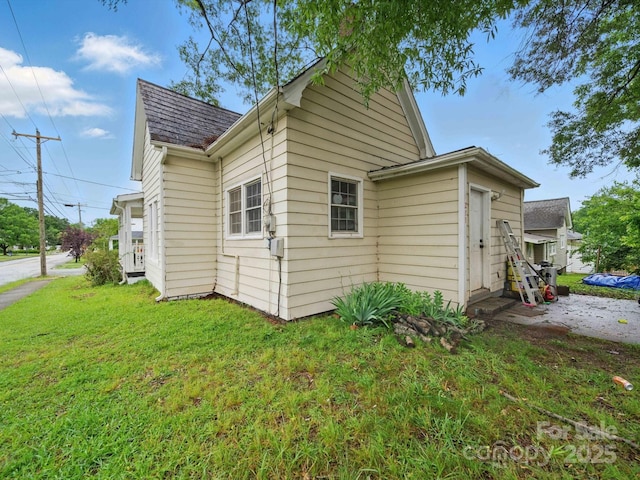 211 S Rowan Ave, Spencer, NC 28159 - view of side of property with a yard and a shingled roof