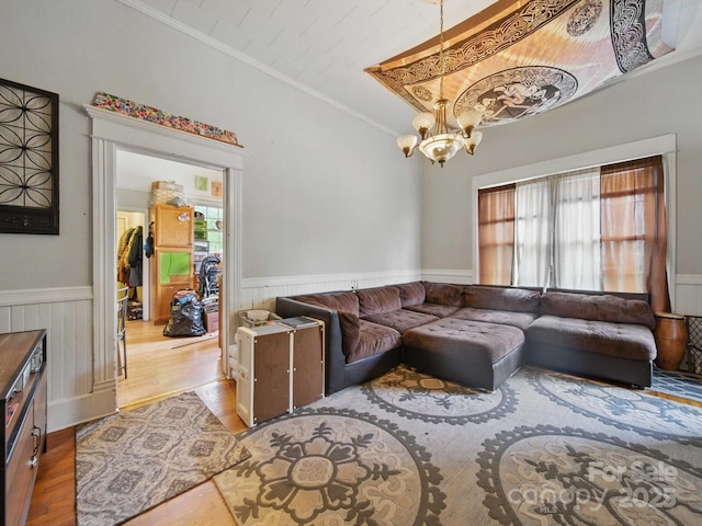 211 S Rowan Ave, Spencer, NC 28159 - living room with wood finished floors, plenty of natural light, ornamental molding, a chandelier, and wainscoting
