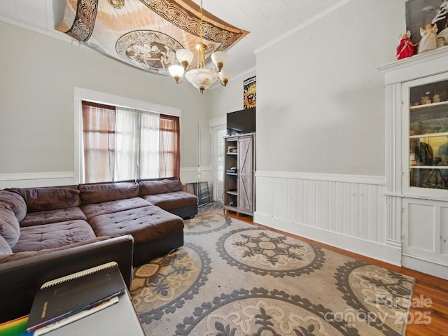 211 S Rowan Ave, Spencer, NC 28159 - living room featuring a chandelier, wood finished floors, crown molding, and wainscoting