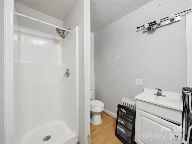 211 S Rowan Ave, Spencer, NC 28159 - bathroom featuring a shower stall, toilet, wood finished floors, vanity, and a textured ceiling
