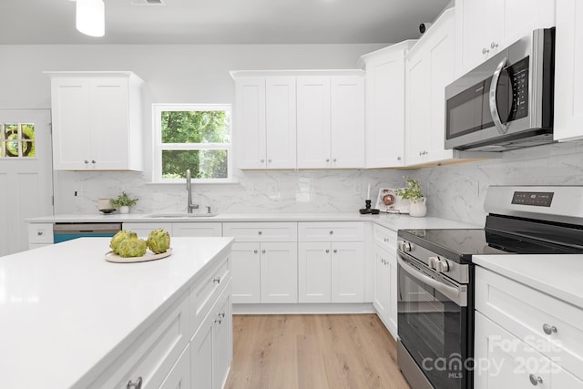 1815 Wildwood Dr, Charlotte, NC 28214 - kitchen with appliances with stainless steel finishes, a sink, light countertops, and decorative backsplash