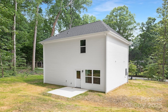 1815 Wildwood Dr, Charlotte, NC 28214 - rear view of property featuring a patio area, a lawn, and a shingled roof