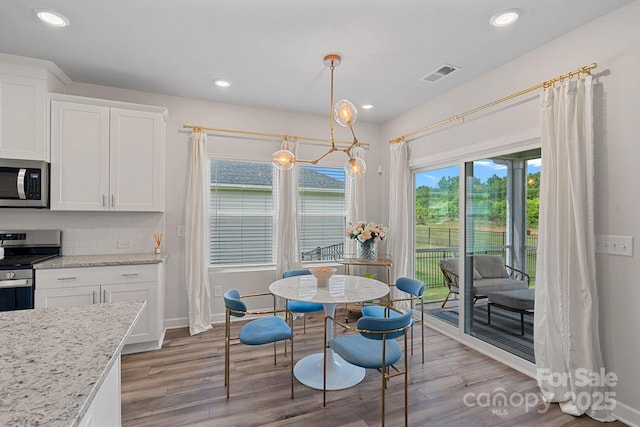 1344 Sweet Pea St, Monroe, NC 28110 - dining space with wood finished floors, recessed lighting, and baseboards