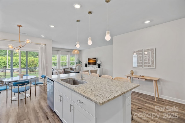 1344 Sweet Pea St, Monroe, NC 28110 - kitchen with a sink, stainless steel dishwasher, a chandelier, light wood-style flooring, and a kitchen island with sink