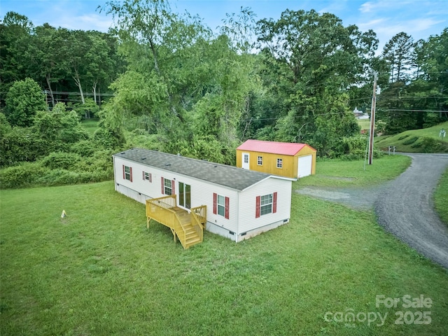 38 Kemp Rd, Pisgah Forest, NC 28768 - view of front of house with driveway, a shingled roof, a front lawn, an outdoor structure, and crawl space