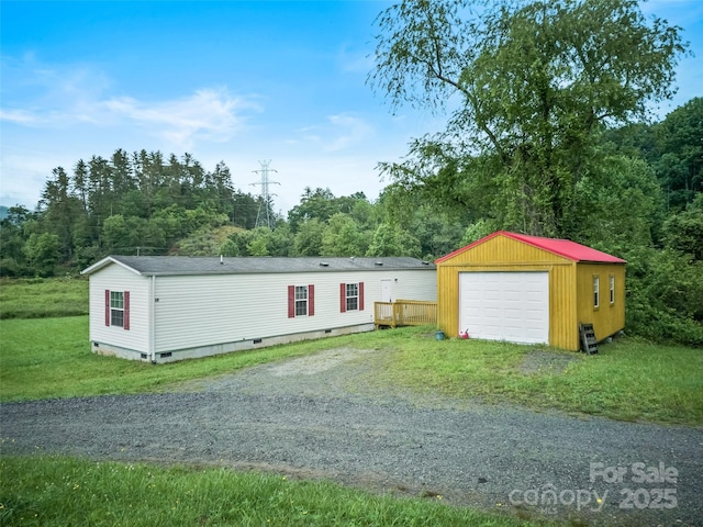 38 Kemp Rd, Pisgah Forest, NC 28768 - view of front of home with driveway, crawl space, an outbuilding, a garage, and roof with shingles