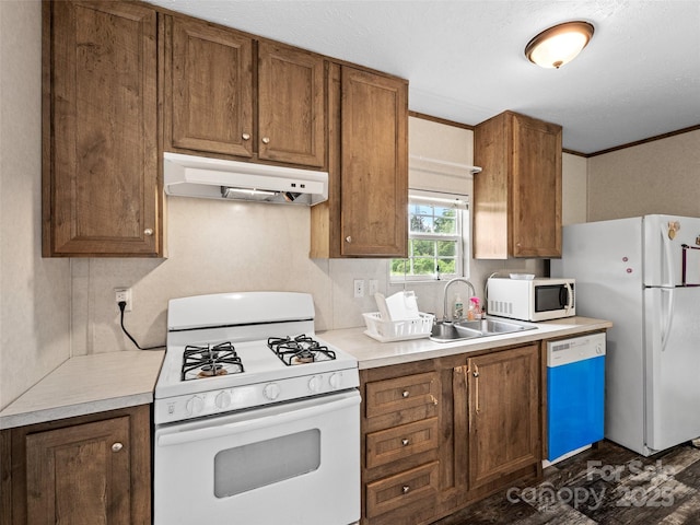 38 Kemp Rd, Pisgah Forest, NC 28768 - kitchen featuring white appliances, under cabinet range hood, a sink, brown cabinetry, and light countertops