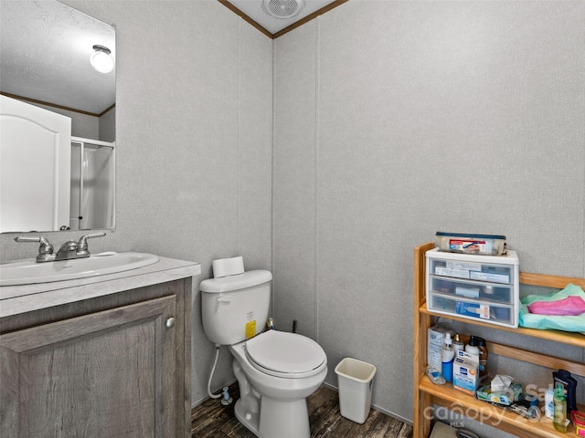 38 Kemp Rd, Pisgah Forest, NC 28768 - full bathroom with wood finished floors, vanity, toilet, and a shower with shower door