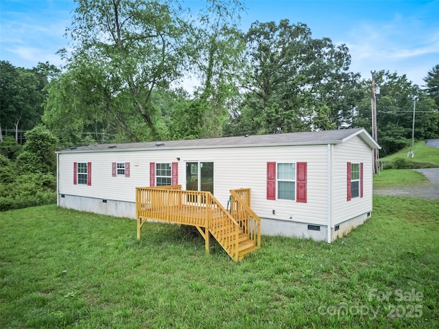 38 Kemp Rd, Pisgah Forest, NC 28768 - rear view of property featuring crawl space, a deck, and a lawn