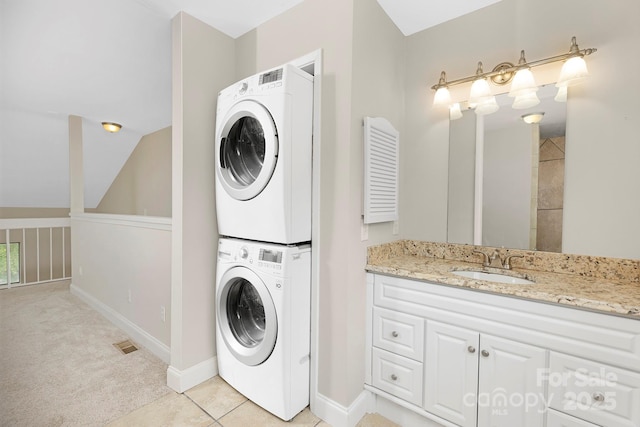 6101 Heath Ridge Ct, Charlotte, NC 28210 - laundry area with stacked washer / drying machine, light carpet, and baseboards