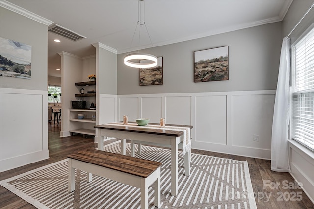 360 Sundown Rd, Mooresville, NC 28117 - dining area with wood finished floors, ornamental molding, a wainscoted wall, and a decorative wall