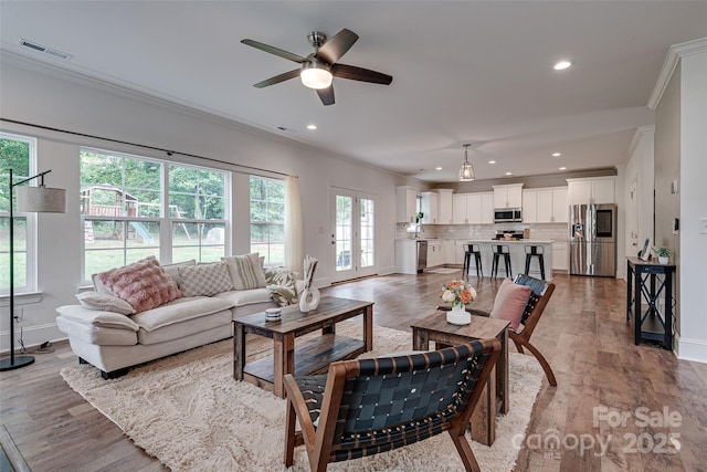 360 Sundown Rd, Mooresville, NC 28117 - living area featuring ornamental molding, baseboards, wood finished floors, a ceiling fan, and recessed lighting